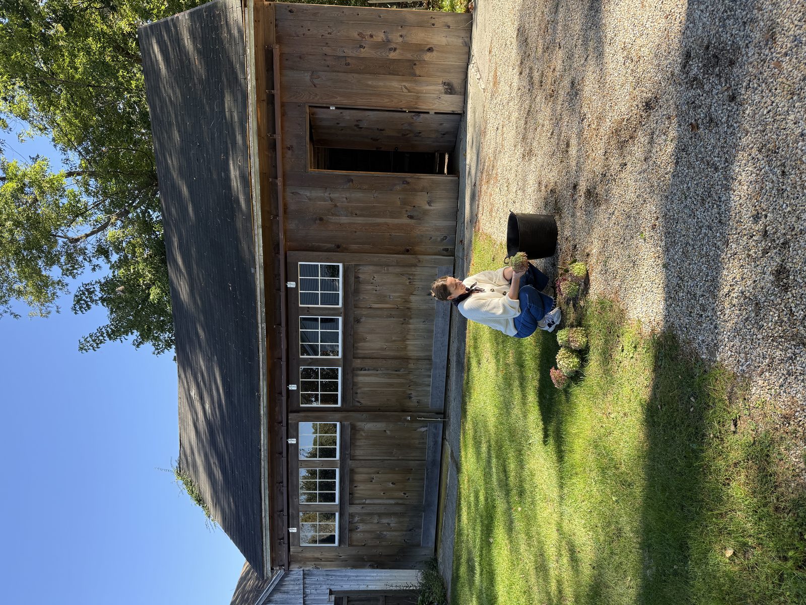Gravel courtyard with cedar barn — Connecticut.